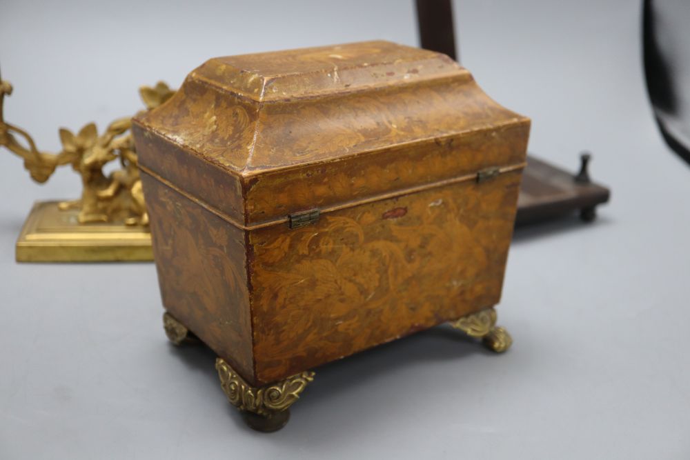 A William IV penwork tea caddy, a pair of ormolu Bacchanalian cherub candlesticks, lacking sconces and a hardwood dish stand